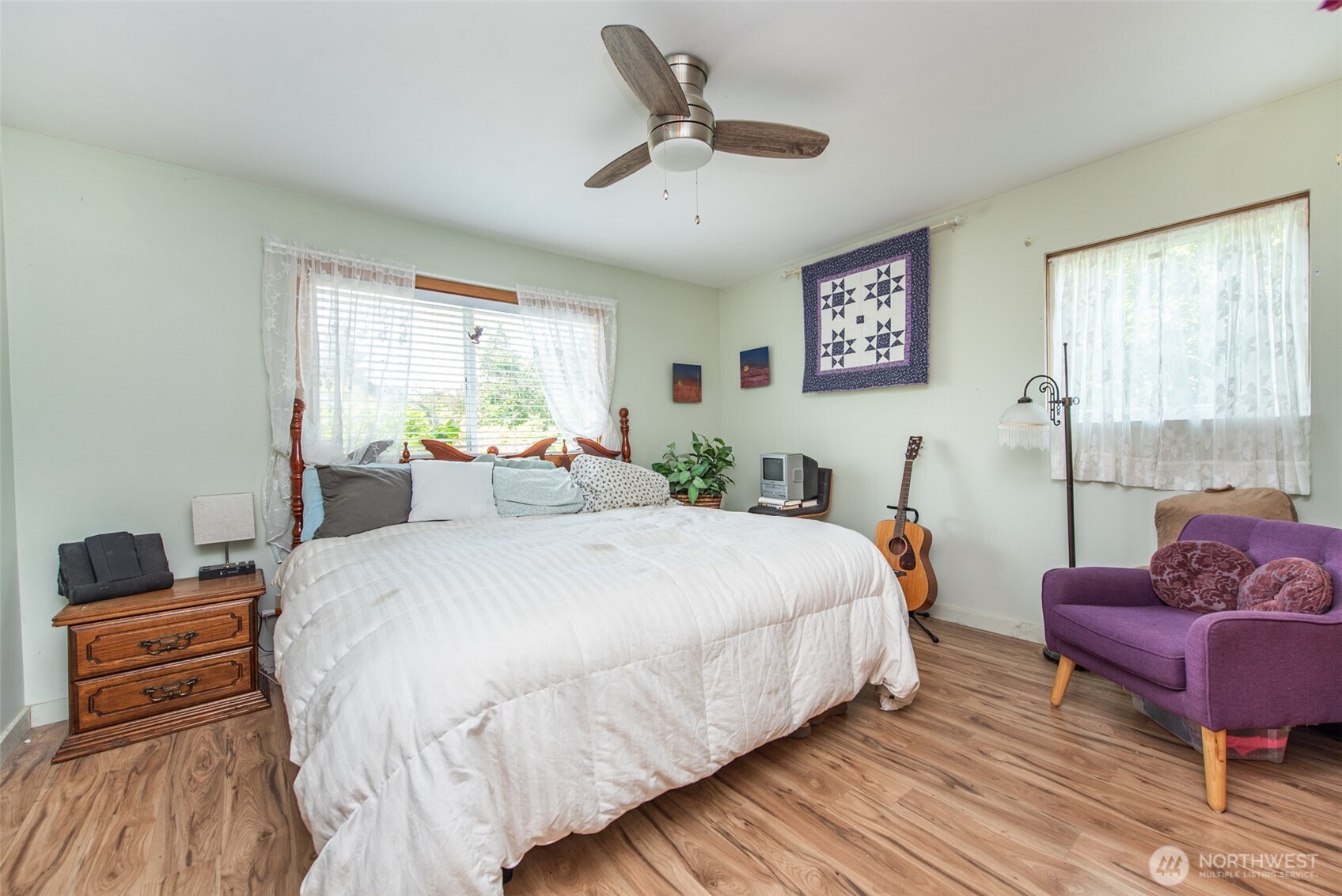307 East Fir Street Sequim, WA 98382 - Photo 18 of 29 a bedroom with a bed and wooden floor