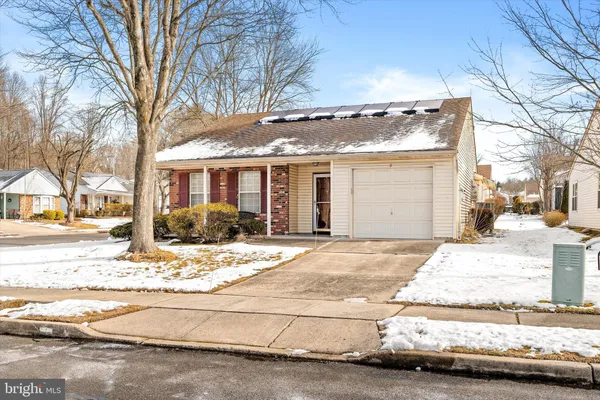 a view of the house with snow on the road