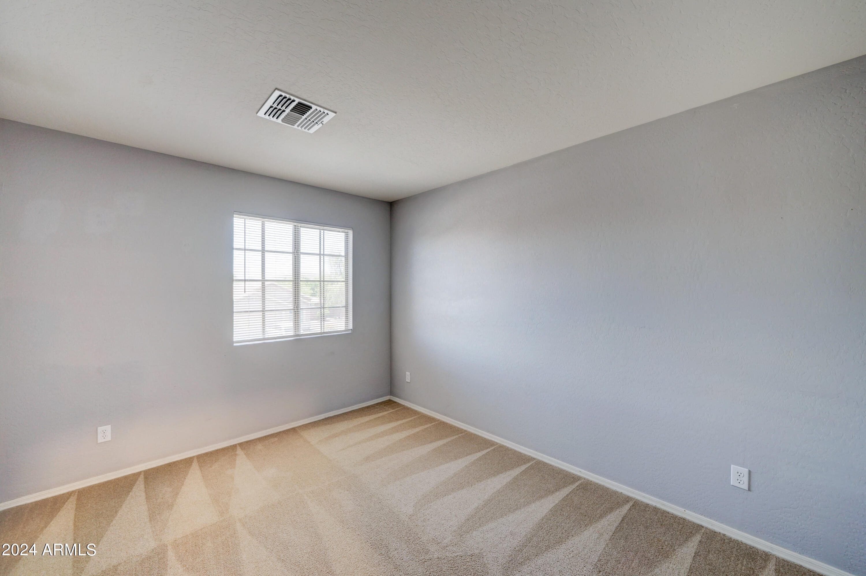 2554 West Tanner Ranch Road San Tan Valley, AZ 85144 - Photo 25 of 39 a view of an empty room with a window