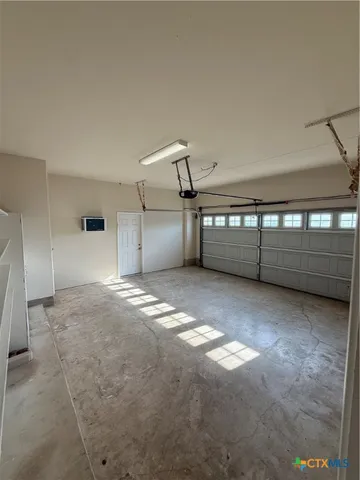 a view of a kitchen with a sink and a refrigerator