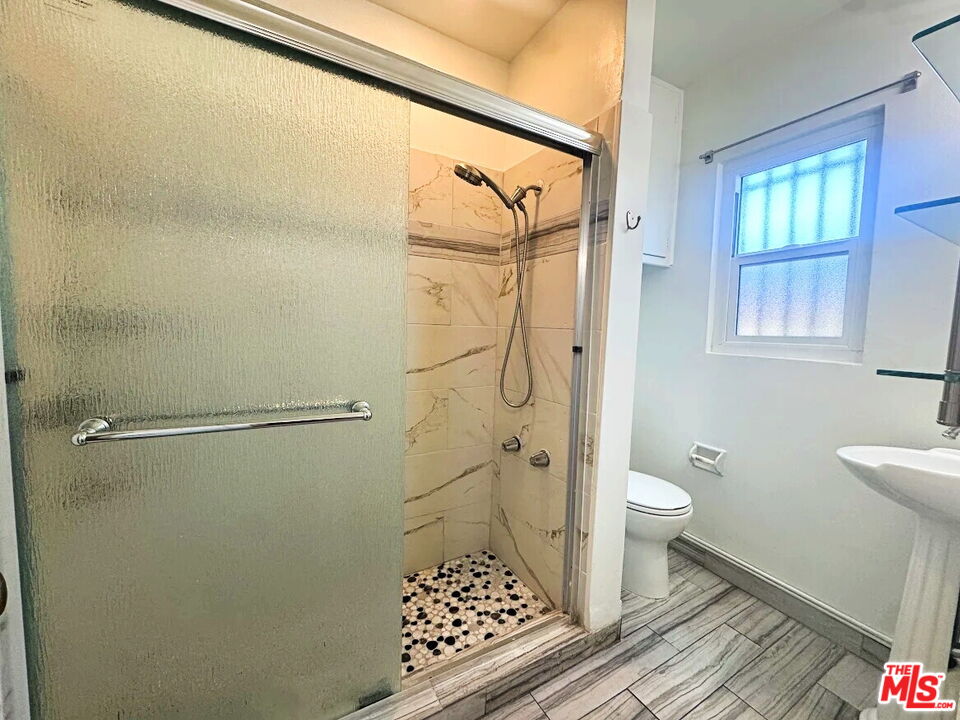 110 South Rampart Boulevard, Unit 3 Los Angeles, CA 90057 - Photo 13 of 17 a bathroom with a sink toilet and shower