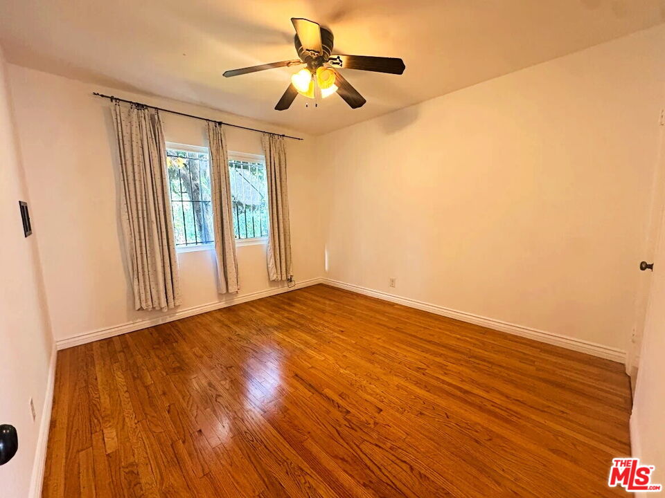 110 South Rampart Boulevard, Unit 3 Los Angeles, CA 90057 - Photo 5 of 17 a view of an empty room with window and wooden floor