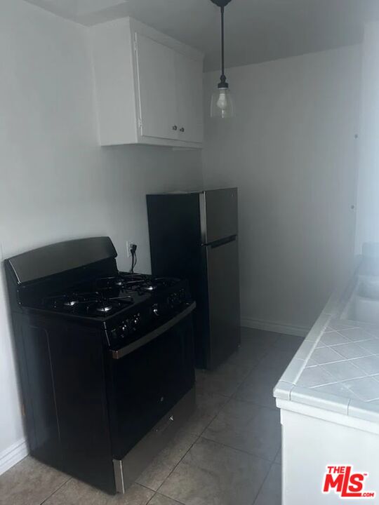 110 South Rampart Boulevard, Unit 3 Los Angeles, CA 90057 - Photo 10 of 17 a kitchen with a stove and a cabinet