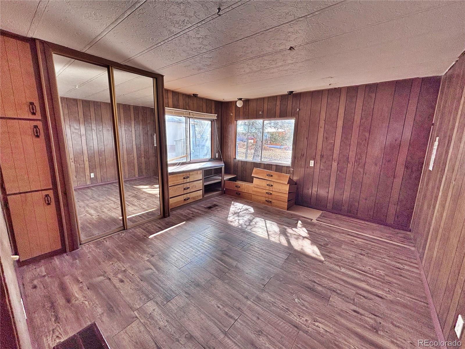 1114 Reed Lane La Junta, CO 81050 - Photo 19 of 22 a view of an empty room with window and wooden floor