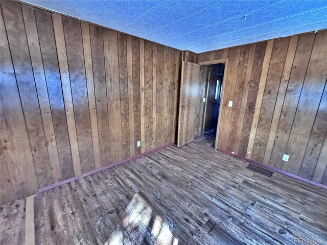 a view of a room with wooden walls