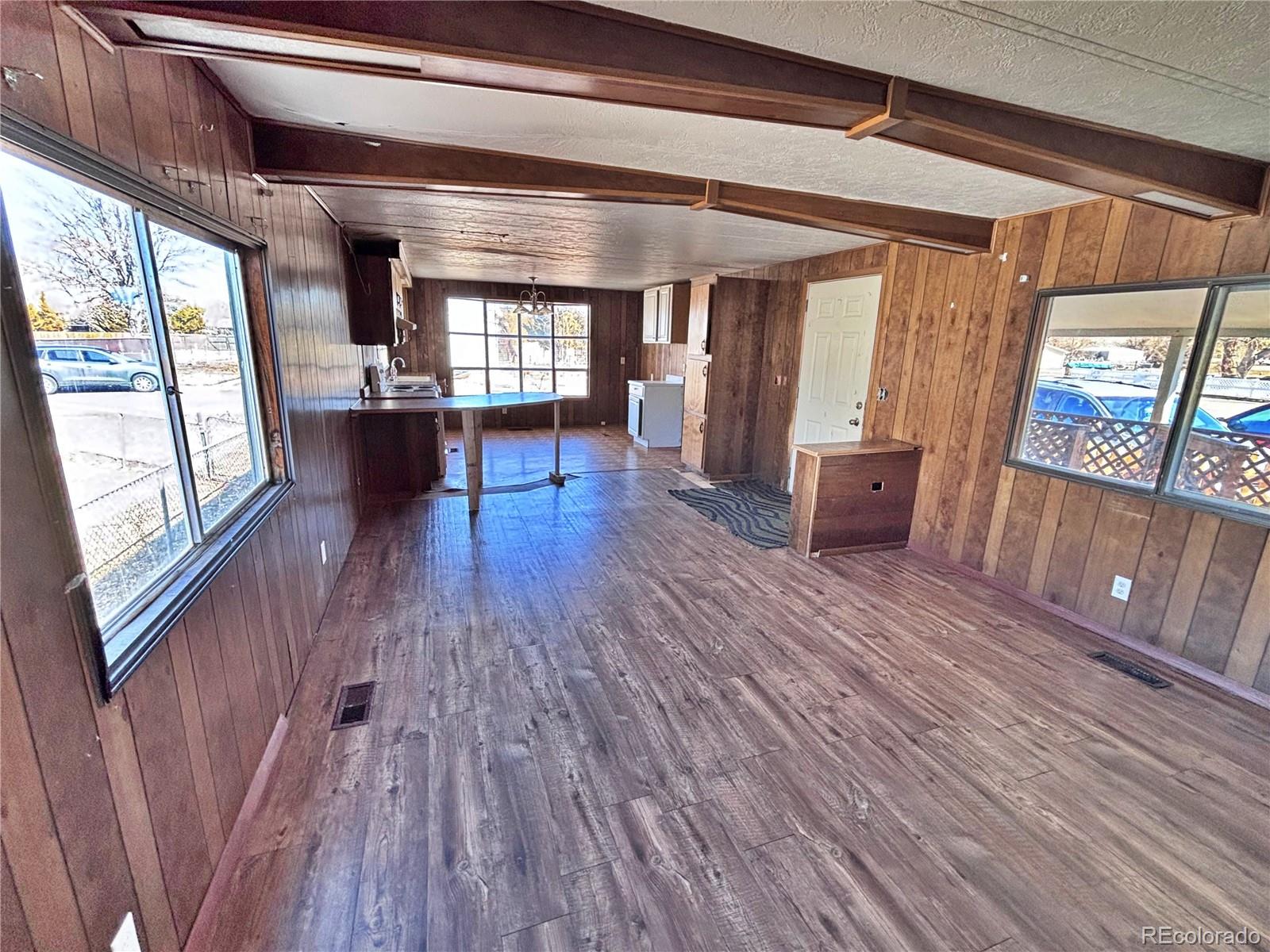 1114 Reed Lane La Junta, CO 81050 - Photo 22 of 22 a living room with furniture and a wooden floor