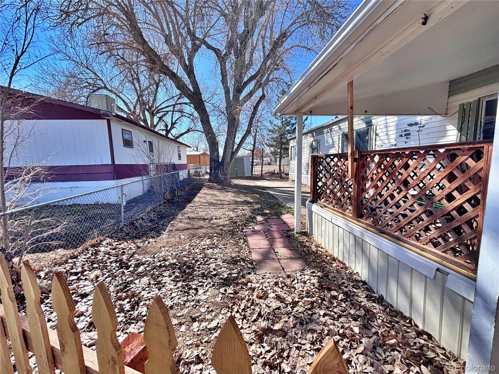 1114 Reed Lane La Junta, CO 81050 - Photo 3 of 22 a front view of a house with a yard