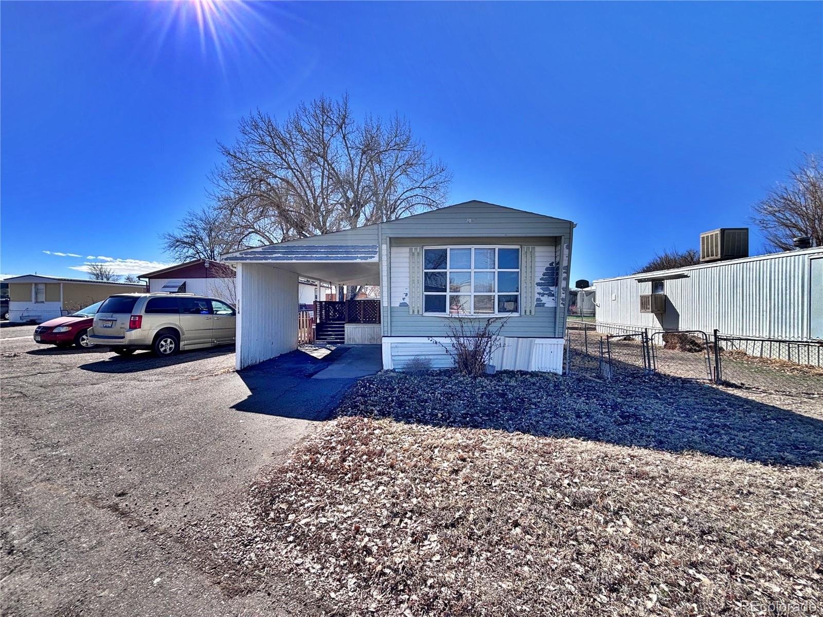 1114 Reed Lane La Junta, CO 81050 - Photo 3 of 26 a front view of a house with a yard and garage