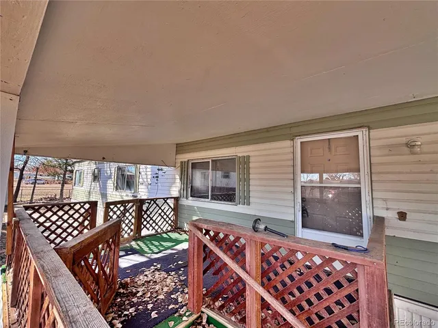 a balcony view with a sink and wooden floor