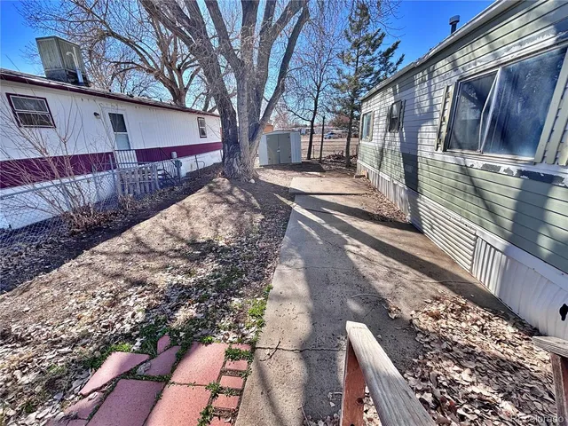 a view of a yard with wooden fence