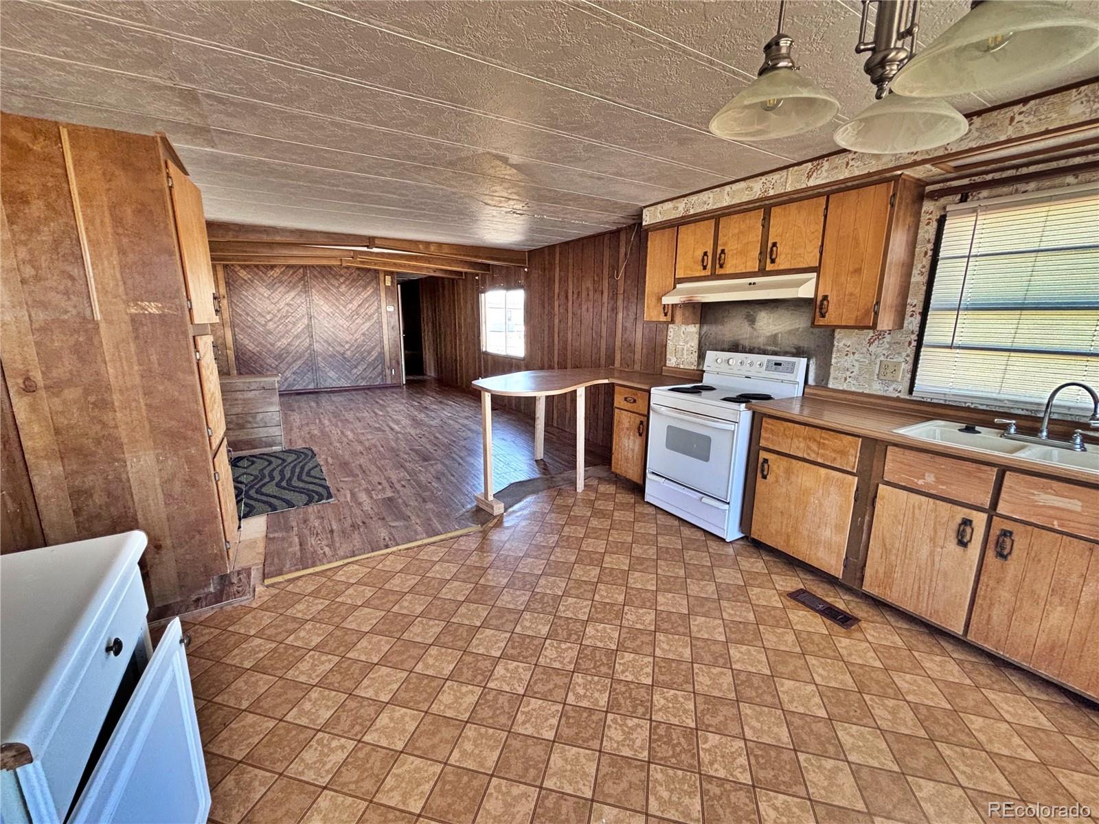 1114 Reed Lane La Junta, CO 81050 - Photo 9 of 22 a kitchen with sink cabinets and window