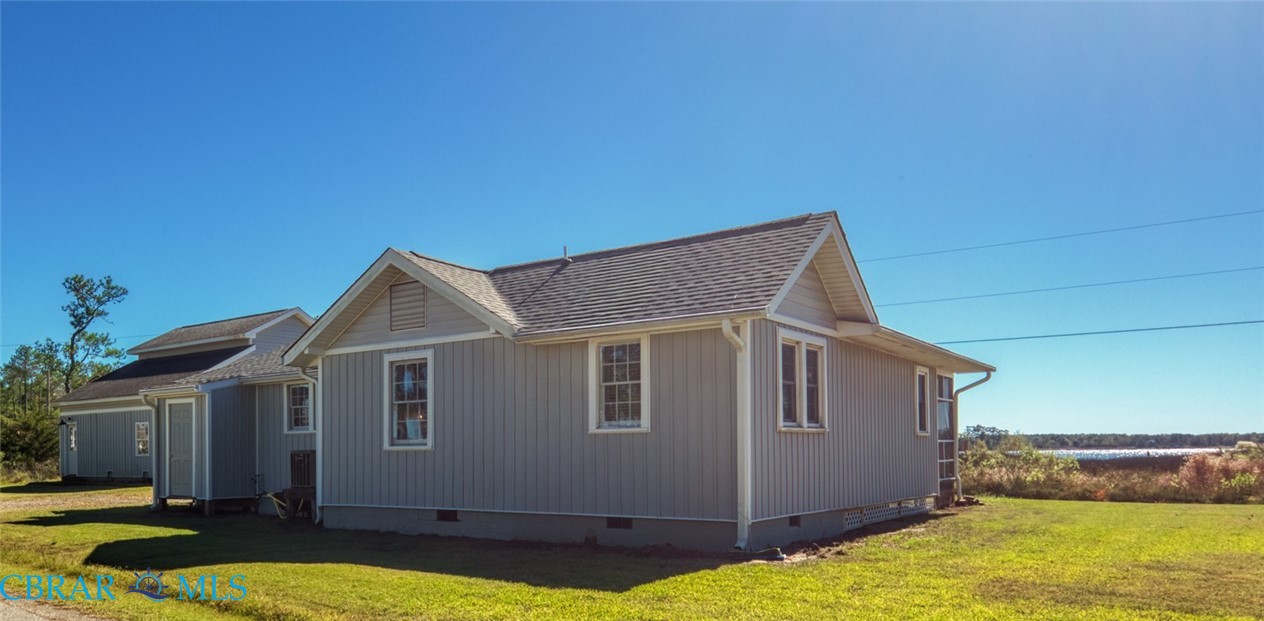 9078 Stump Point Road Hayes, VA 23072 - Photo 2 of 28 View of property exterior with crawl space, a lawn, and roof with shingles