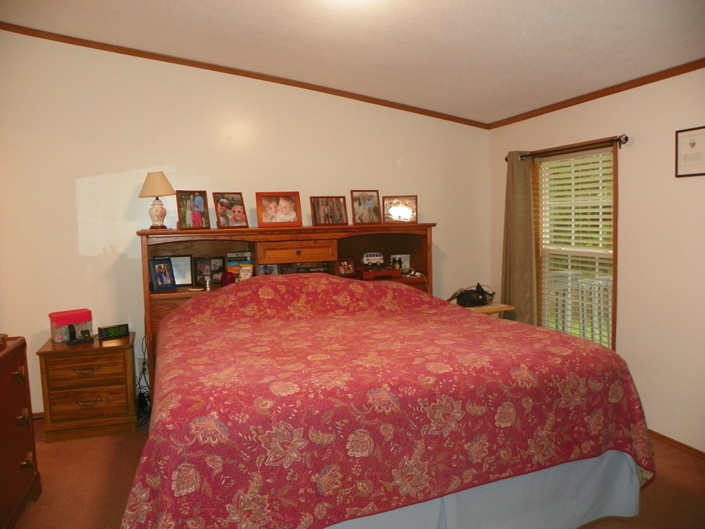2268 German Hill Road Tionesta, PA 16353 - Photo 13 of 31 a bed sitting in a bedroom next to a window with a book shelf