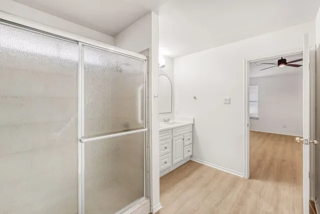 a bathroom with a shower and a glass door