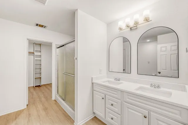 a bathroom with a double vanity sink and mirror