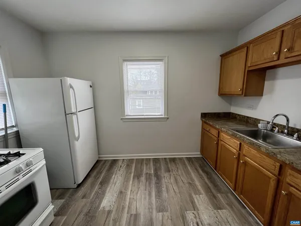 a kitchen with sink a refrigerator and a stove