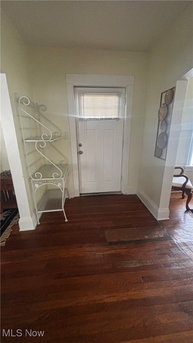 15710 Hazel Road Cleveland, OH 44112 - Photo 3 of 44 Foyer entrance with dark wood-style flooring and baseboards