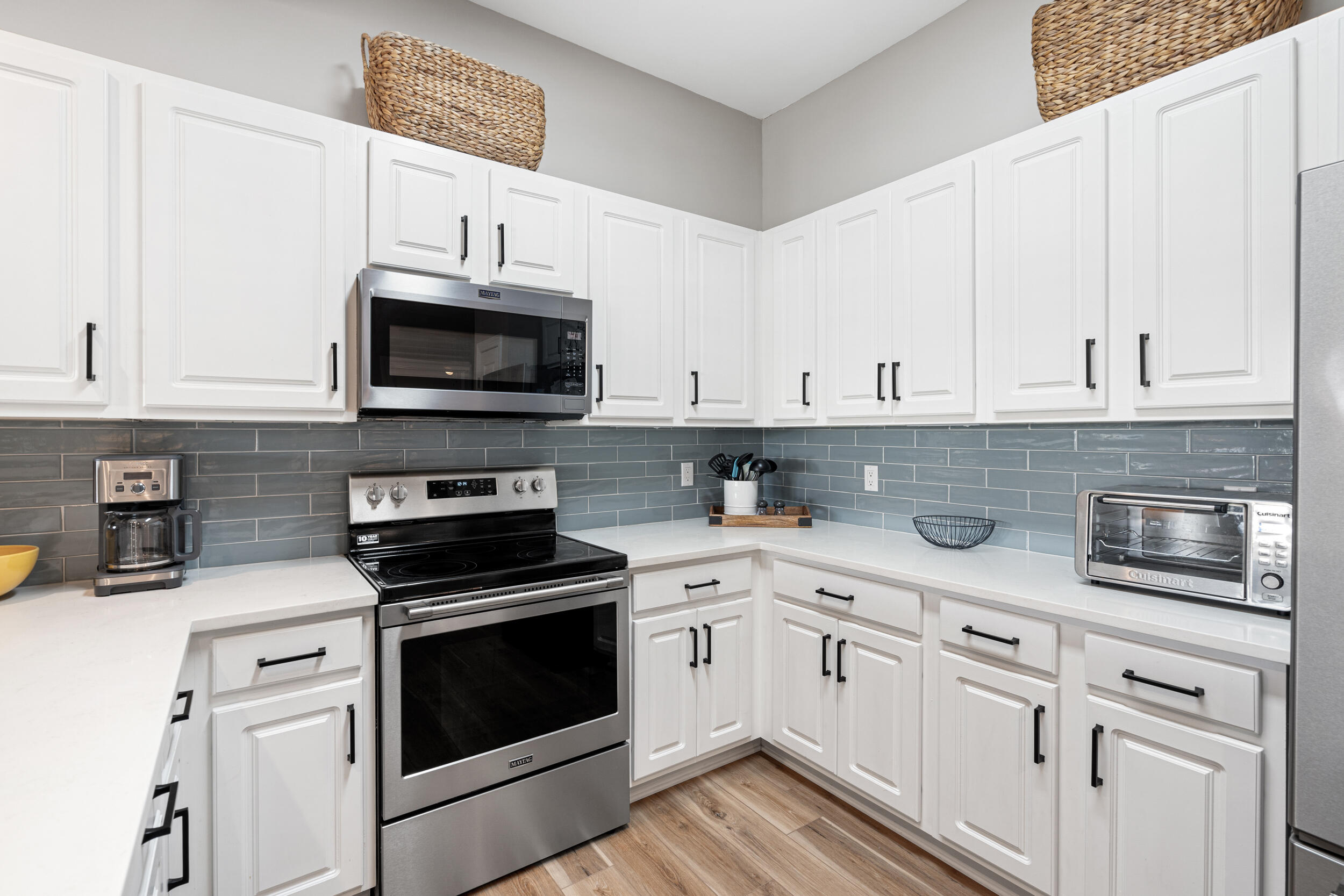 2410 Scenic Gulf Drive, Unit 201C Miramar Beach, FL 32550 - Photo 14 of 39 a kitchen with white cabinets and appliances