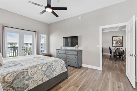 a bedroom with a bed and a flat tv screen on dresser