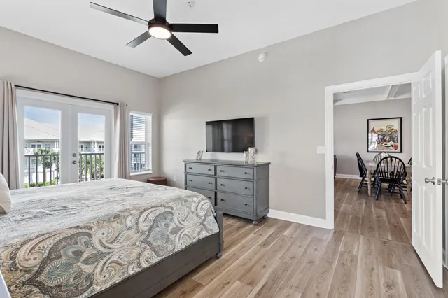 a bedroom with a bed and a flat tv screen on dresser
