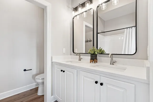 a bathroom with a double vanity sink and a mirror