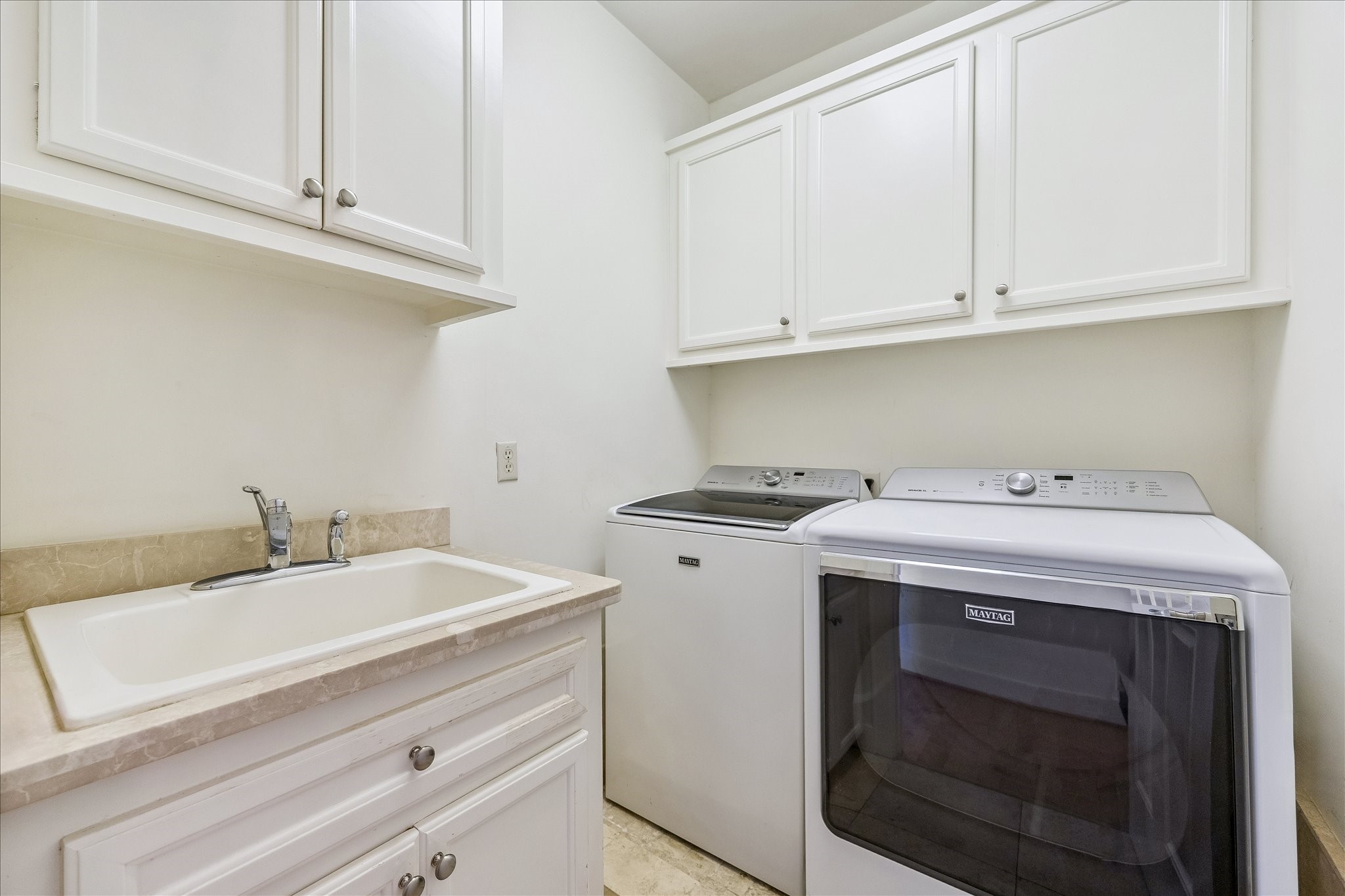 4010 Milton Street Houston, TX 77005 - Photo 31 of 49 LAUNDRY. A dedicated utility room features built-in cabinetry, countertop workspace, and a utility sink for the hand wash only clothes.
