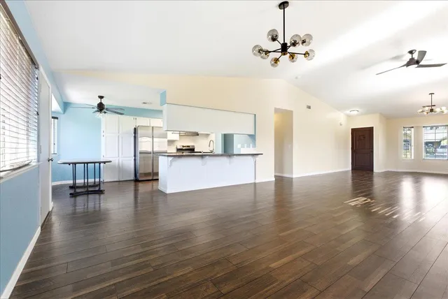 a view of a kitchen with a sink and a refrigerator