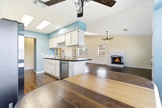 a kitchen with kitchen island a sink stainless steel appliances and cabinets