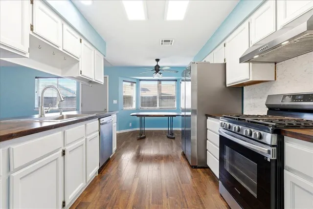 a kitchen with wooden floors and a stove