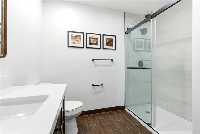 a bathroom with a toilet and a shower