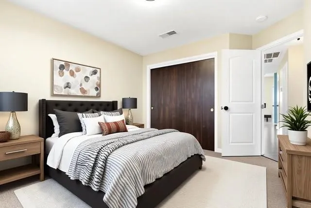 a bedroom with bed and painting on the wall