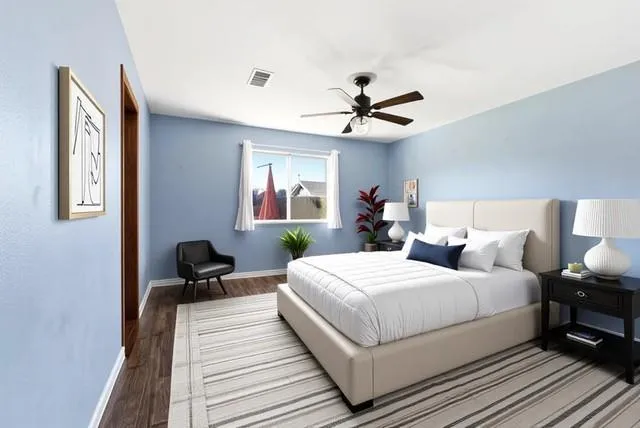 a bedroom with a large bed and a chandelier