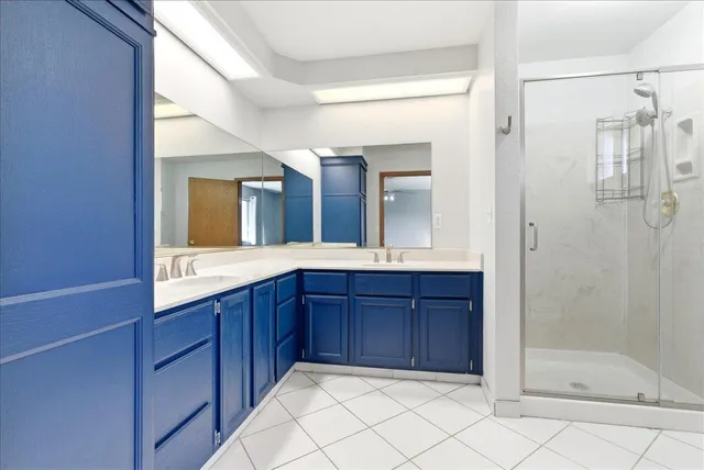 a bathroom with a double vanity sink and a mirror