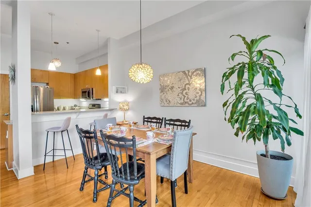 a dining room with furniture and potted plants
