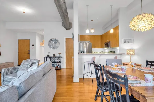 a living room with furniture and potted plants