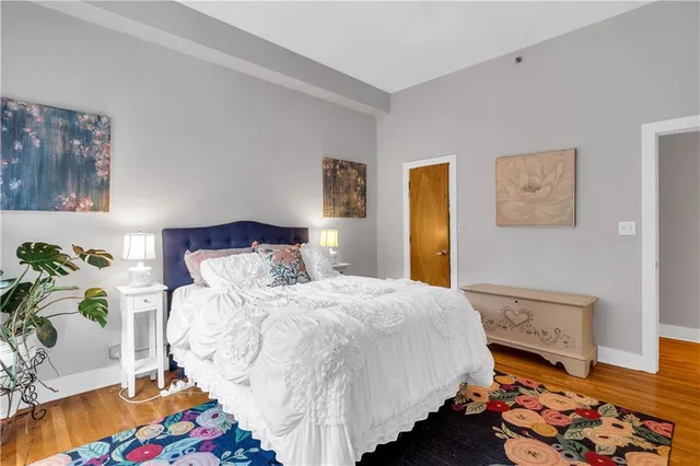 a bedroom with a bed and wooden floor