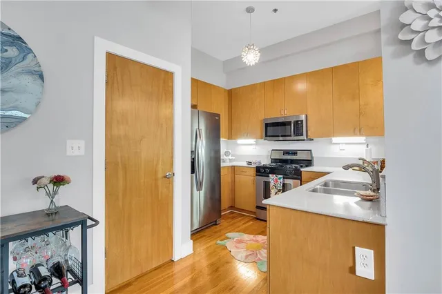 a kitchen with stainless steel appliances granite countertop a refrigerator stove and sink