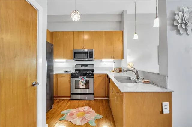 a kitchen with stainless steel appliances a sink stove and refrigerator