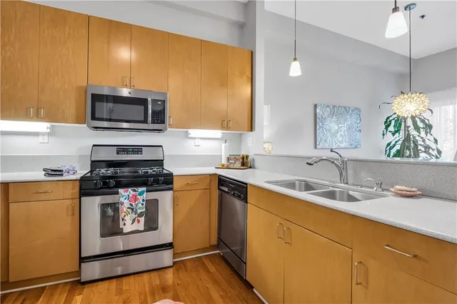 a kitchen with a sink a stove and microwave