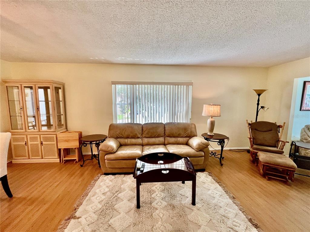 2292 Costa Rican Drive, Unit 22 Clearwater, FL 33763 - Photo 12 of 44 a living room with furniture and a wooden floor