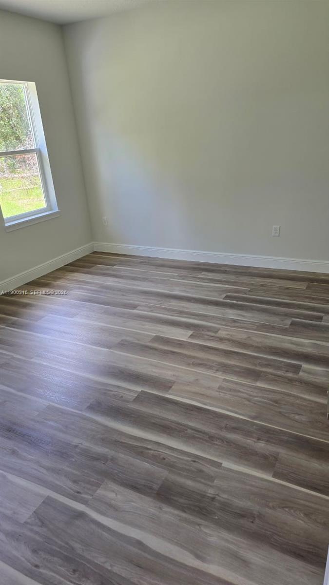 16855 Southwest 18th Avenue Road, Unit 16855 Ocala, FL 34473 - Photo 13 of 16 a view of a room with wooden floor and a window