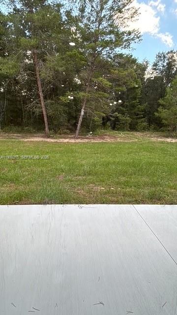 16855 Southwest 18th Avenue Road, Unit 16855 Ocala, FL 34473 - Photo 16 of 16 a view of a swimming pool with a yard