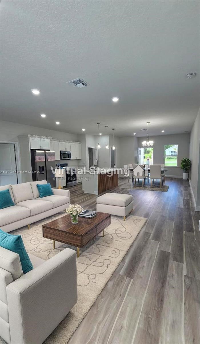 16855 Southwest 18th Avenue Road, Unit 16855 Ocala, FL 34473 - Photo 2 of 16 a living room with furniture and kitchen view
