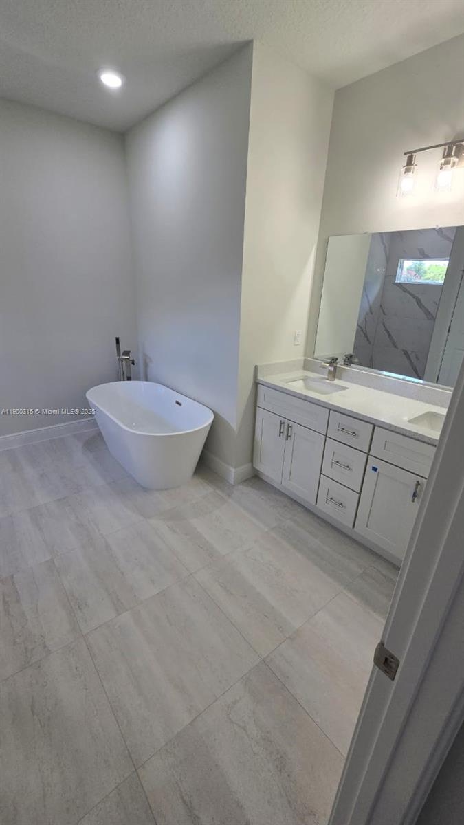 16855 Southwest 18th Avenue Road, Unit 16855 Ocala, FL 34473 - Photo 10 of 16 a spacious bathroom with a tub sink and mirror