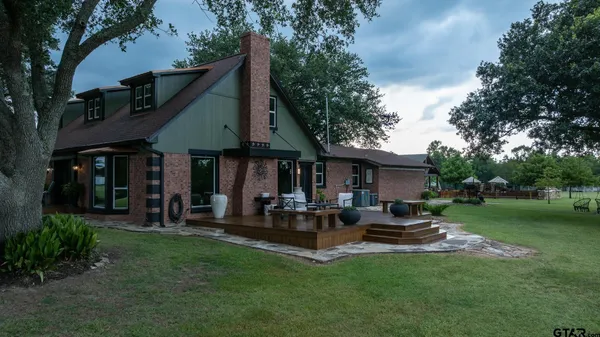 a view of a house with a yard porch and sitting area