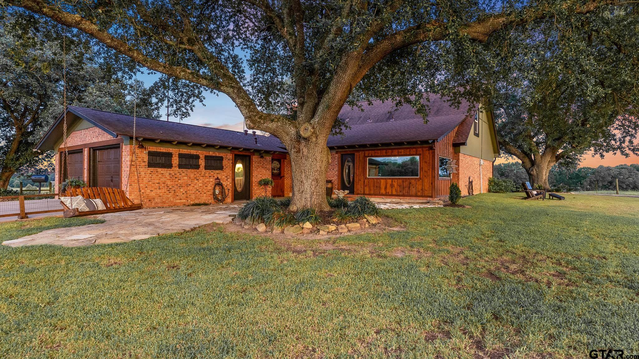 668 County Road 108 Carthage, TX 75633 - Photo 15 of 42 a front view of a house with a yard
