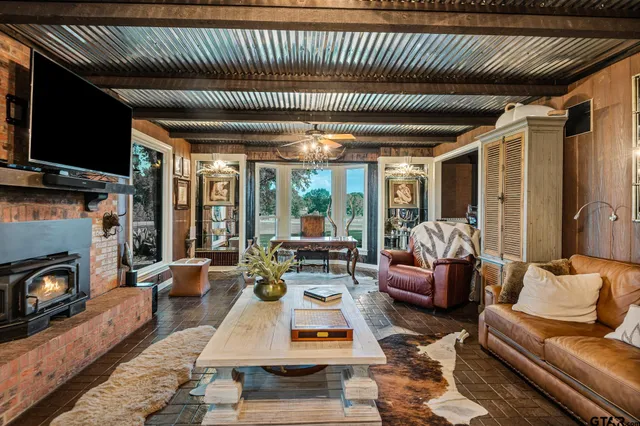 a living room with furniture fireplace and flat screen tv