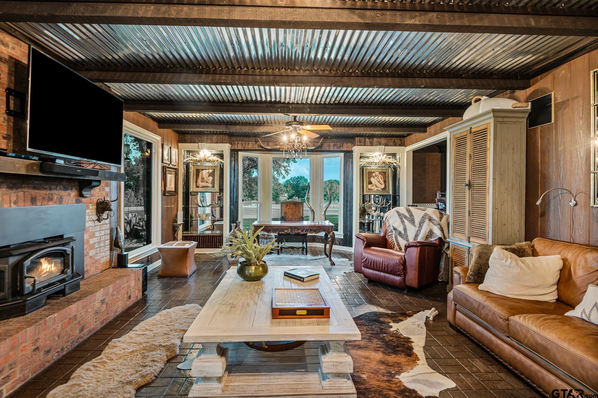 668 County Road 108 Carthage, TX 75633 - Photo 16 of 42 a living room with furniture fireplace and flat screen tv