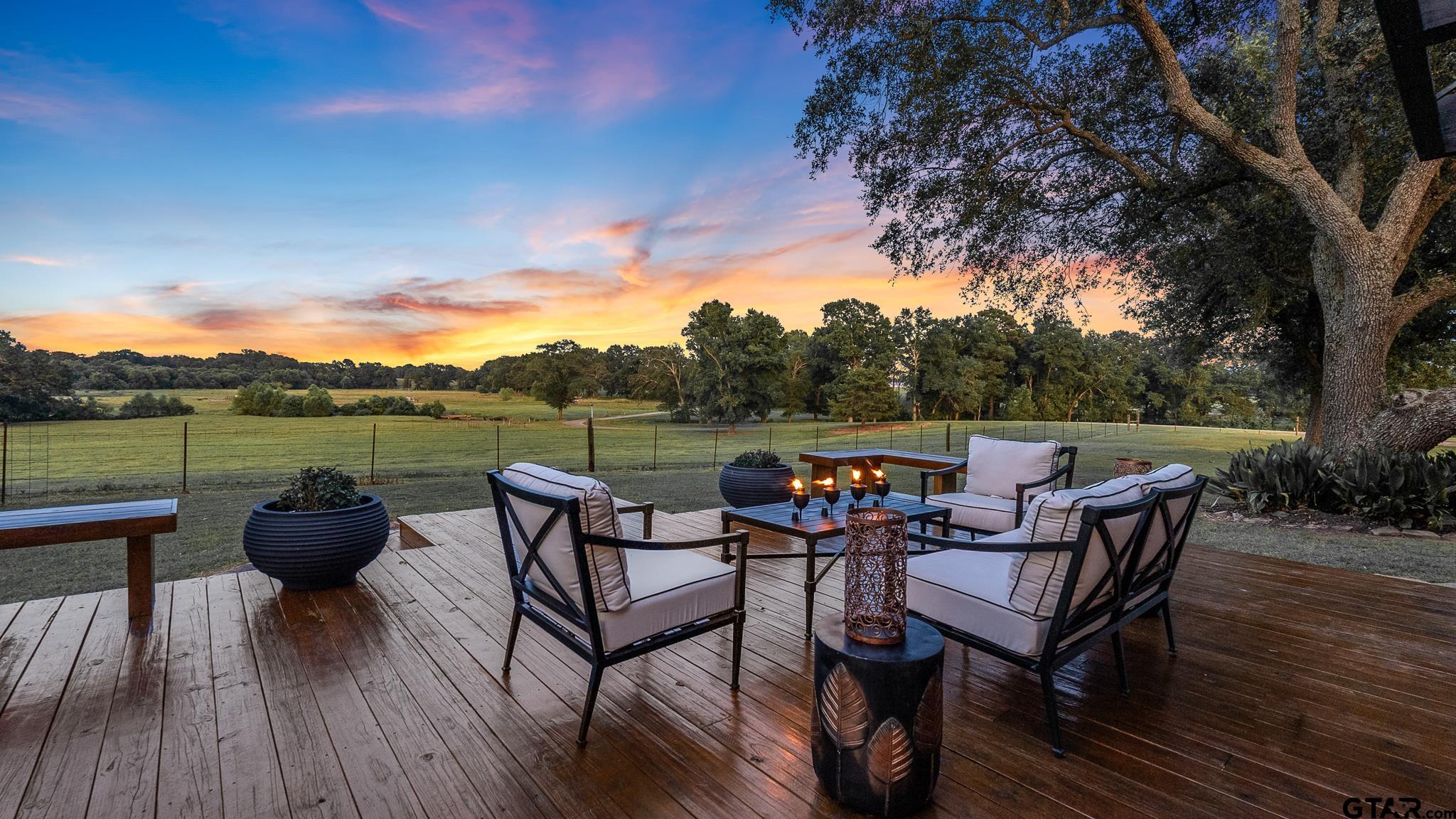 668 County Road 108 Carthage, TX 75633 - Photo 2 of 42 a backyard of a house with wooden floor and outdoor seating