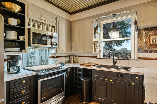 a kitchen with a sink stove and cabinets